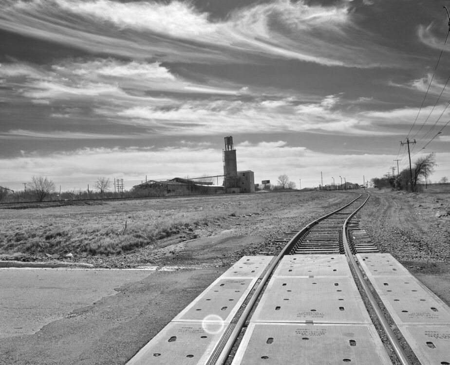 sky, built structure, architecture, the way forward, building exterior, diminishing perspective, railroad track, cloud - sky, vanishing point, landscape, field, tower, road, transportation, rail transportation, no people, day, outdoors, cloud, travel destinations