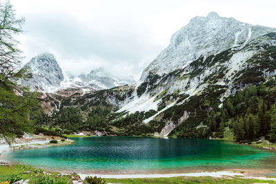 Scenic view of snowcapped mountains with seebensee lake infront