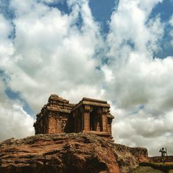 Low angle view of historic building against cloudy sky