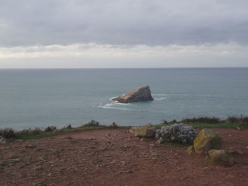 Scenic view of sea against cloudy sky