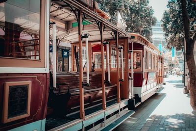 Train on street by buildings in city