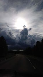 Road amidst trees against sky