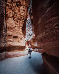 Rear view of woman standing on rock