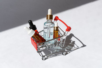 Close-up of shopping cart against white background
