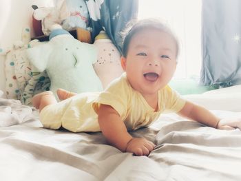 Cute baby boy sleeping on bed at home