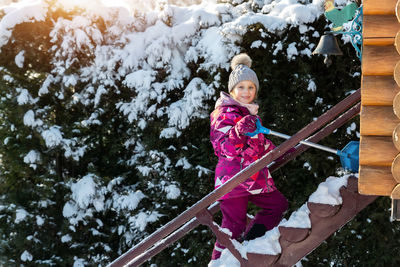 Low angle view of young woman standing on staircase