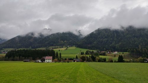 Scenic view of rural landscape against cloudy sky