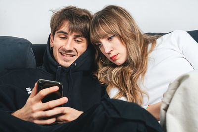 Portrait of young woman using phone