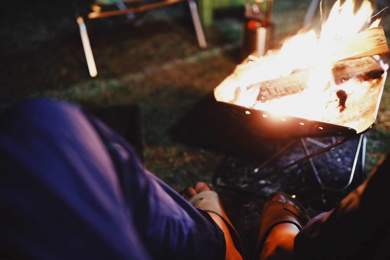 LOW SECTION OF MAN WITH FIRE ON BARBECUE