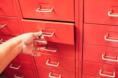 Cropped hand opening red locker