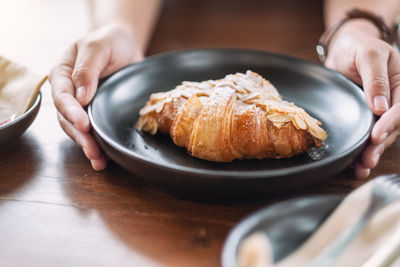 Midsection of woman holding ice cream in plate