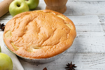 Traditional charlotte apple pie charlotte on concrete table with fresh apple and cinnamon 