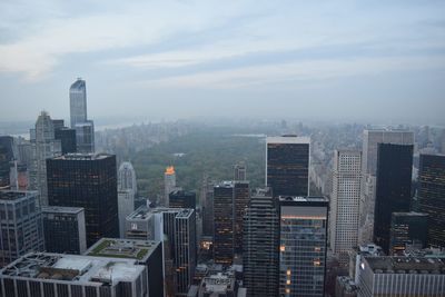 Skyscrapers against cloudy sky