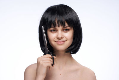 Portrait of a smiling young woman over white background