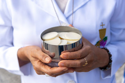 Midsection of doctor holding coffee