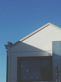 Low angle view of building against clear blue sky