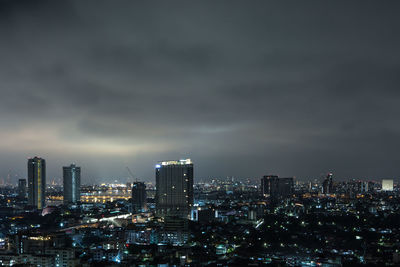 Illuminated cityscape against sky