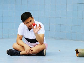 Young woman sitting on floor