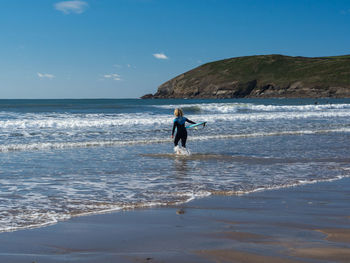 Surfer girl heading out at croyde 