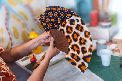 Close-up of woman holding a spanish fan. handmade