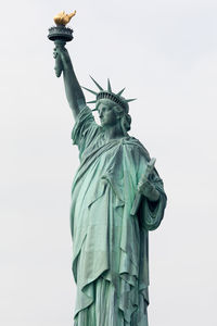 Low angle view of statue of liberty against sky