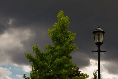 Low angle view of street light against cloudy sky