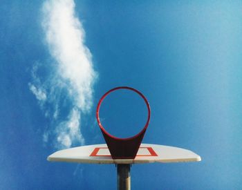 Directly below shot of basketball hoop against blue sky