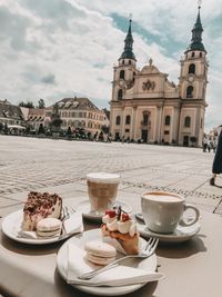 Breakfast served on table in city against sky