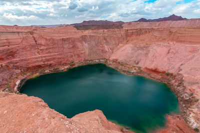 Scenic view of lake and mountain against cloudy sky