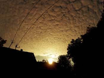 Low angle view of built structure at sunset