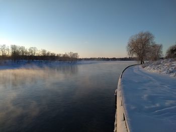 Scenic view of lake against sky during winter