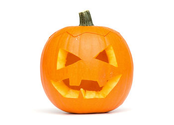Close-up of pumpkin face against white background