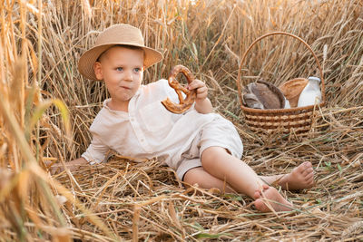 Portrait of cute girl sitting on hay