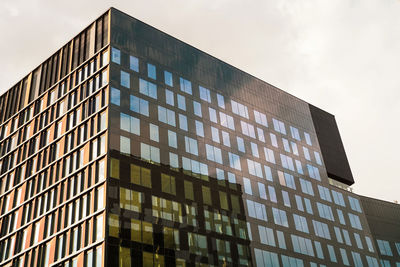 High corporate modern urban architecture building with glass windows and reflection of building 