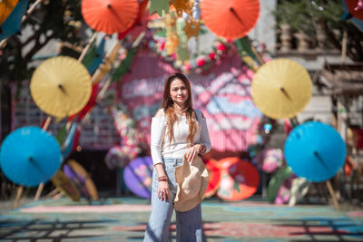 Portrait of a smiling young woman standing outdoors