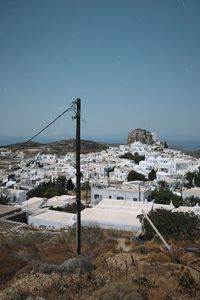 Buildings in town against clear blue sky