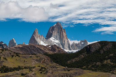 Scenic view of mountains against cloudy sky