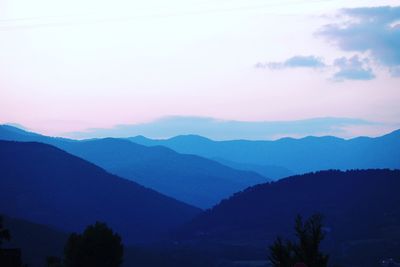 Scenic view of silhouette mountains against sky at sunset