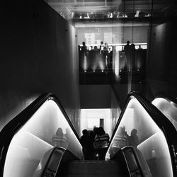Woman sitting on escalator