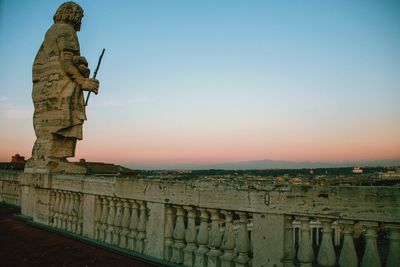 Statue against clear sky during sunset