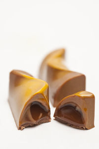 Soft filled caramel pralines on white background