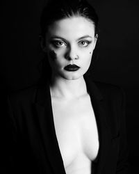 Portrait of sensuous young woman against black background