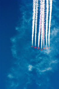 Low angle view of airplane flying against blue sky