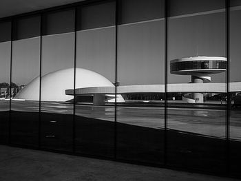 Centro niemeyer seen through glass window against sky