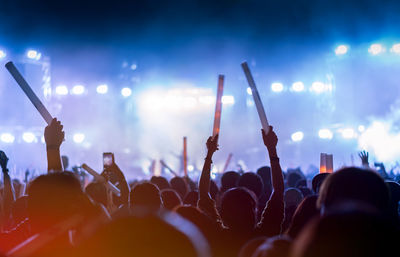 Rear view of people enjoying at music concert