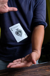 Midsection of man playing poker