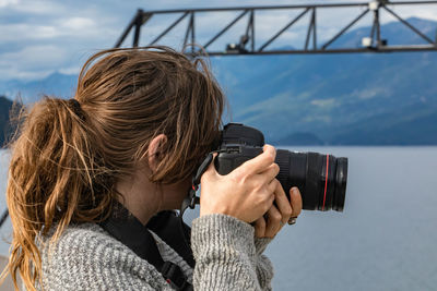 Rear view of woman photographing