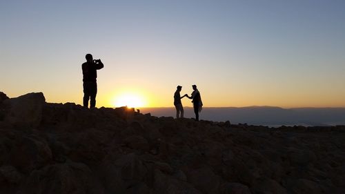 Silhouette of people at sunset