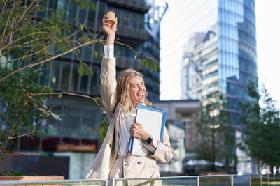 Low angle view of man standing against buildings