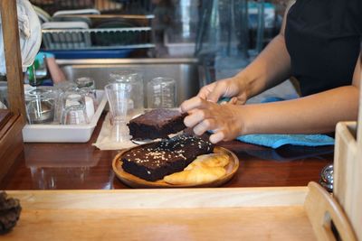 Midsection of woman preparing food in restaurant